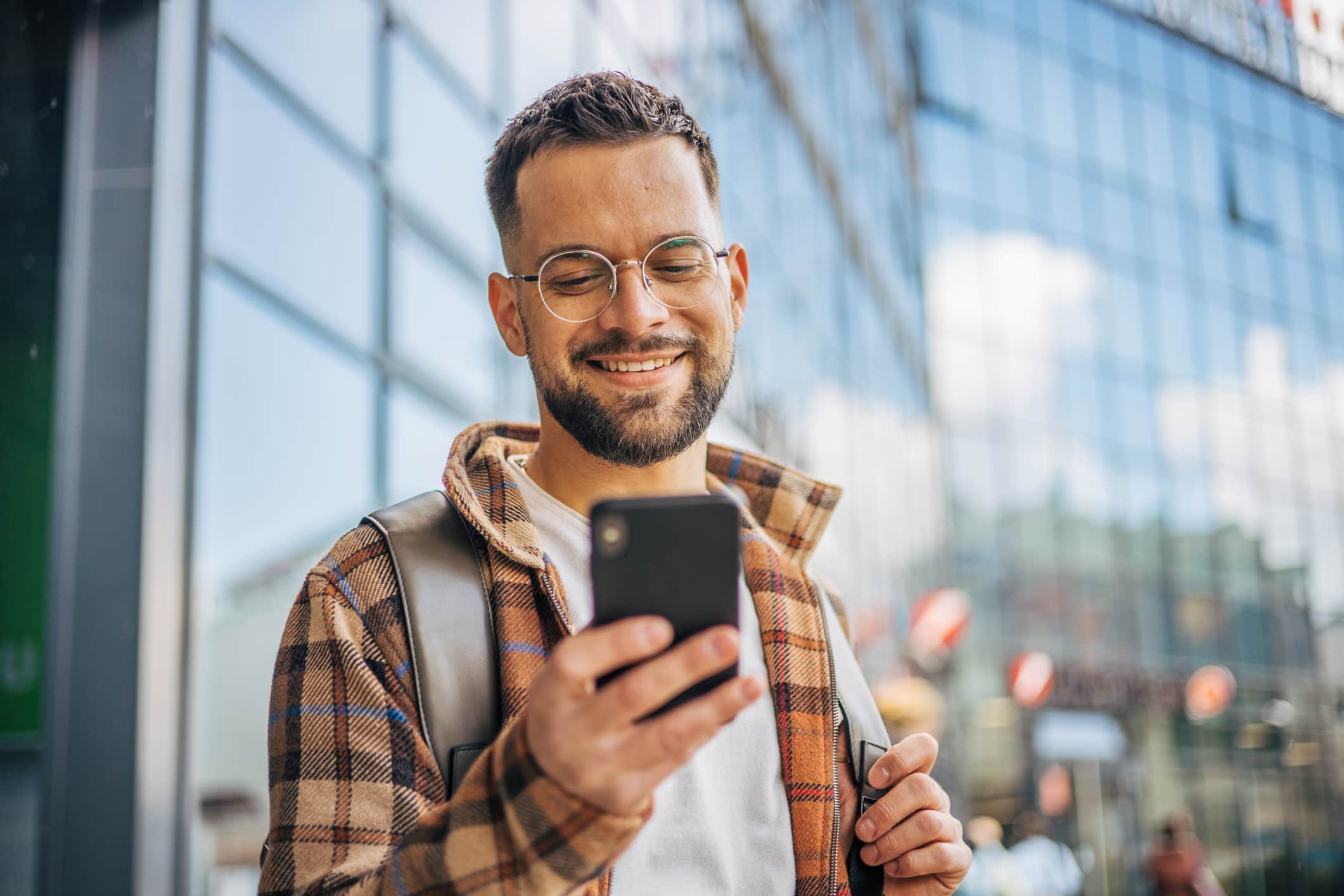 A Smiling Adult Man Walked Out Of The Office Building After Finishing Work.