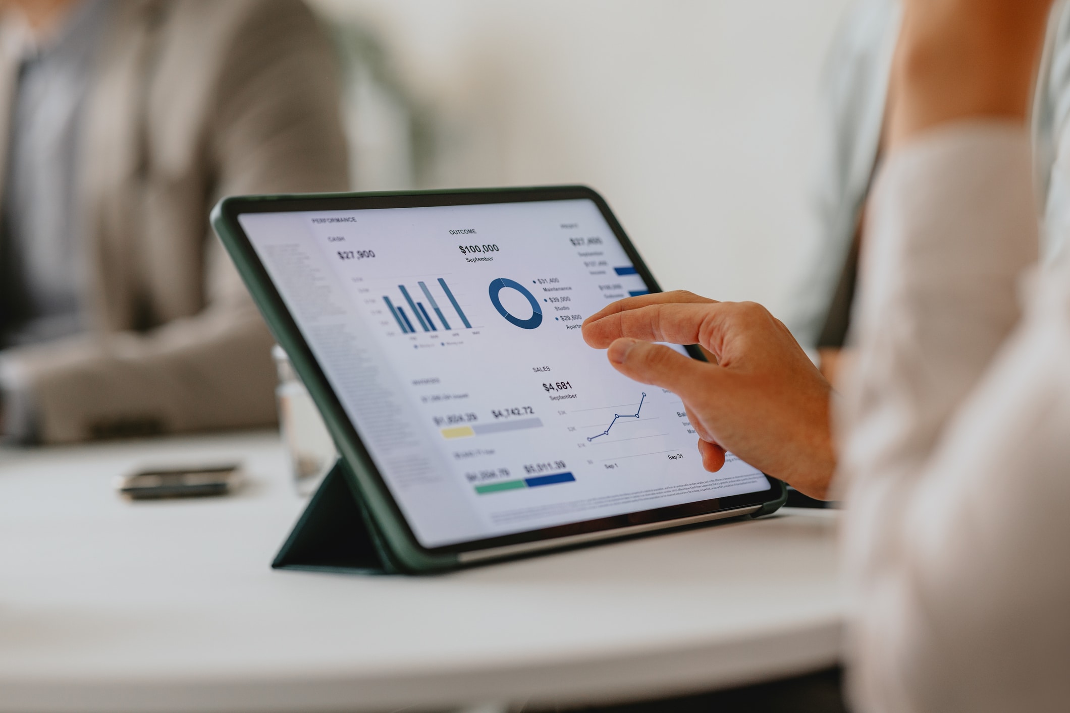 Business Team Analyzing Data On Digital Tablet During Meeting